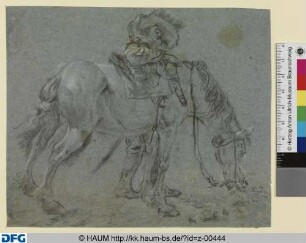 Reiter, neben seinem Pferd stehend