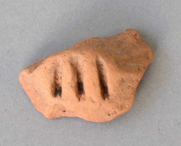 Fragment of a clay vessel decoration