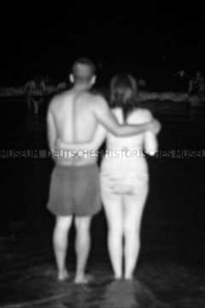 Rückansicht eines Pärchens am Strand bei Nacht in der "Noche de San Juan" (Altersgruppe D)