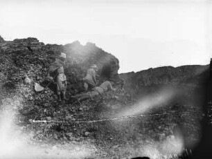 Am Nyiragongo Krater : Zwei Forschungsreisende und ein Begleiter am Krater des Nyiragongo, vermutlich während des Durchführens von Messungen
