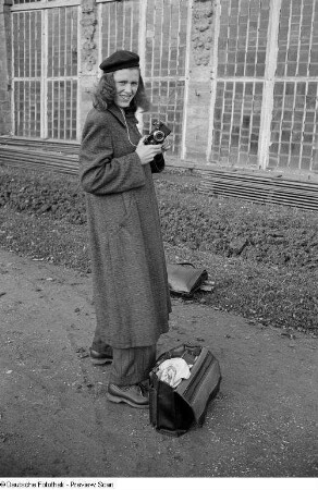 Renate Rössing mit Kamera vor der Gärtnerei der Orangerie des Schlosses Belvedere