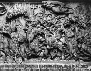 Tympanon mit Kreuzigung : Tympanon mit Kreuzigung (um 1440). Detail mit Madonnenverehrung und Schlachtenszene. Mariazell (Steiermark), Wallfahrtskirche Mariä Geburt, Westfassade