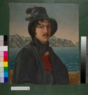 Mann in Tiroler Tracht vor einem See