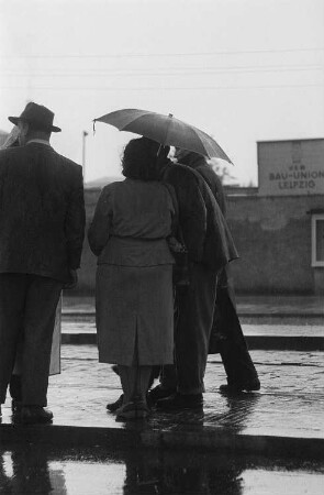 Im Regen wartende Personen