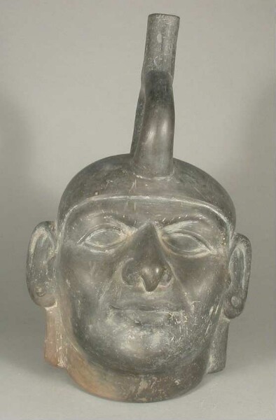 Figure vessel with stirrup spout