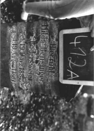 Grabstein 412 (Index: 100111795) Material: Sandstein Zustand: verwittert mit Textverlust Maße HxBxT: 77x43x18 cm Beschreibung: Stele, Sockel, obeliskenartiger Abschluß, Schriftfeld eingetieft mit Rundbogenabschluß Symbolik: Rundbogenfries Besonderheit: Kindergrab: Grabstein 412A