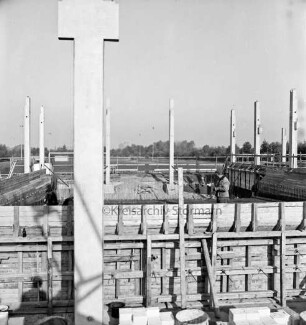 Sporteinrichtungen: Soltausredder: Sporthalle: Bau: vorn Holzverschalungen, Stahlbetonträger und Baumaterial: rechts Arbeiter: hinten Sportplatz und Bäume