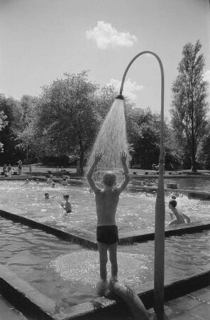Bitterfeld. Schwimmbad. Junge unter der Dusche am Beckenrand