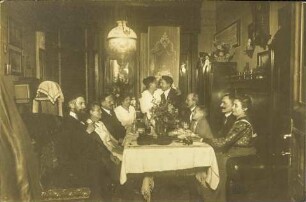 [Paare am Esstisch sitzend mit Musik und Wein]
