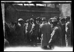 Lille (Dep. Nord, Frankreich): Gefangene mit Feldmütze und Feldmantel in einem ummauerten Vorhof ("Einbringen von Gefangenen auf der Zitadelle Lille")