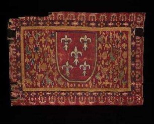 Gewebefragment mit heraldischer Lilie und Vogelmotiv
