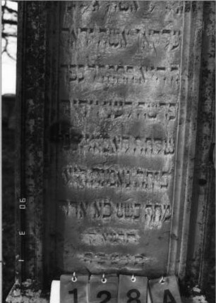 Grabstein 128 (Index: 100114758) Material: Sandstein Zustand: leicht verwittert Maße HxBxT: 196x53x45 cm Beschreibung: Stele auf gestuftem Sockel, Rundbogen, Textteil mit Kleeblattbogen: Grabstein 128 (Detailaufnahme)