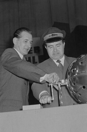 Portrait Heinz Quermanns beim Ziehen von Zahlen während der Ziehung der 52. Spielwoche des VEB Zahlenlotto, links ein weiterer Mann