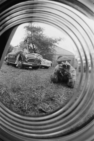 Spiegelungen. Der Fotograf, sich in der Radkappe eines PKWs spiegelnd