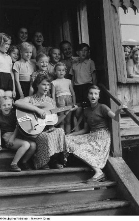 Kinder beim Singen mit Betreuerin im Hauseingang der Alten Winkelmühle