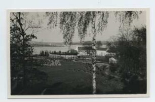 Bauernhof in Mecklenburg (Wohnanlage?), Mecklenburg: Gesamtansicht mit See im Hintergrund