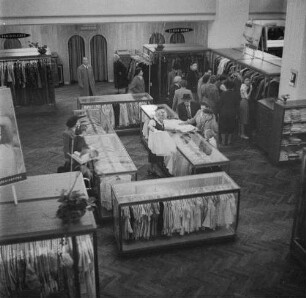 Dresden-Altstadt, Ernst-Thälmann-Straße 25. HO-Warenhaus "Howa". Textilwarenabteilung. Verkäuferin und Kundinnen an Vitrinen mit Blusen