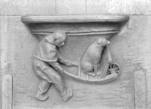 Vierte Misericordie: Mann mit Hund auf einer Schubkarre