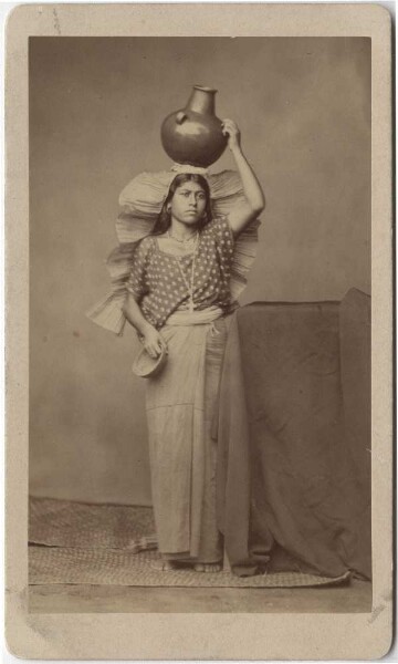 Zapotec woman in traditional costume with jug on her head