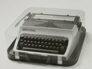 Typenhebelschreibmaschine "daro Erika" (Modell 32). Vorderanschlag (sofort sichtbare Schrift), Universaltastatur, Farbband, Koffermaschine. Schrägansicht von vorn (Phantomaufnahme)