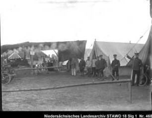 Manöver des 10. Armee-Korps Enthält: Soldaten vor Zelten, im Hintergrund: Hofgebäude und Zuschauer