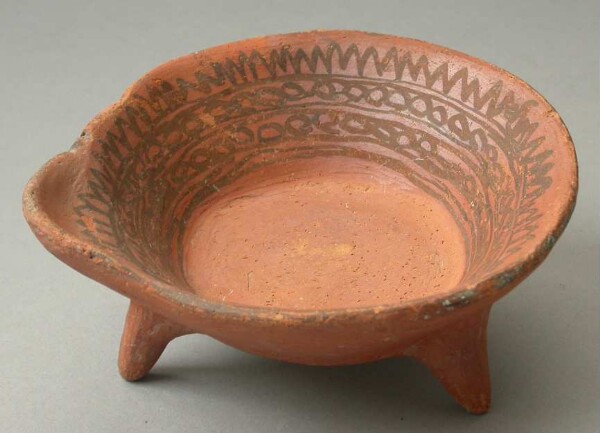 Three-footed clay bowl