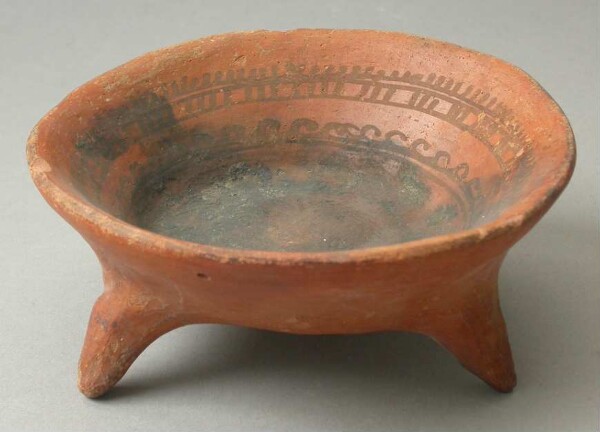 Three-footed clay bowl