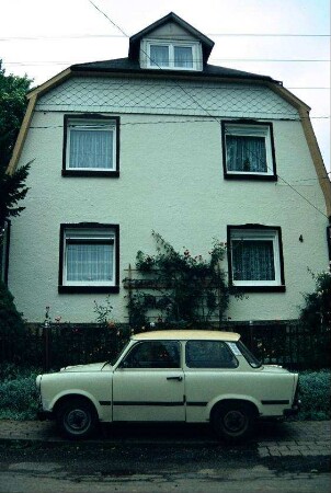 Giebel Wohnhaus, davor Trabant