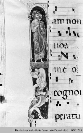 Antiphonar : Textseite mit vierzeiligen Neumen und Miniatur in der Randleiste: Segnender Christus, Atlant, Fabelwesen