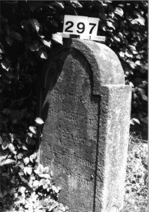 Grabstein 297 (Index: 100085262) Maße HxBxT: 87x52x16 cm Beschreibung: Stele, eingezogener Rundbogenabschluß, Schriftfelder eingetieft: Grabstein 297