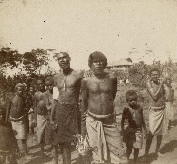 "Group of people, a house in the background, New Britain"