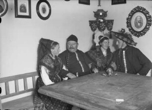 Gruppe in Knoblauchsländer Tracht am Tisch im Museum