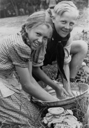 Scharbeutz -Pönitz.Zeltlager. Ein Mädchen und ein Junge waschen ihre Strümpfe in einer kleinen Wanne. Aufgenommen 1947
