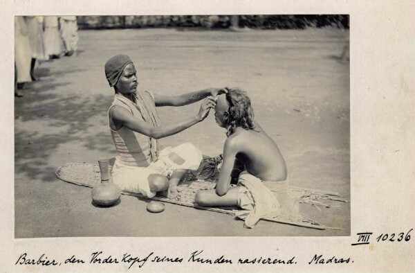 Barber shaving the front of his customer's head