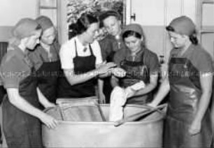 Arbeitsmaiden des Reichsarbeitsdienstes erhalten Unterricht im Wäschewaschen