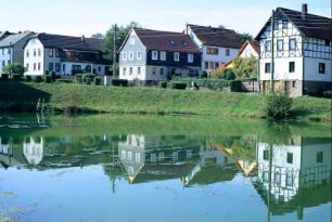 Teich, in dem sich die Häuser spiegeln