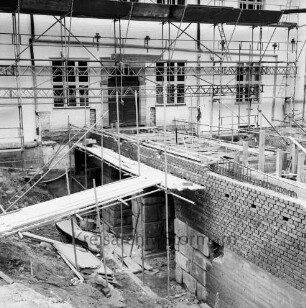 Restaurierung: Brücke vor Eingangsportal: bei Wiederherstellung, mit Gerüst: Aufmauern der Gewölbe mit Klinker, Überweg mit Verschalung, Baustahl-Armierung: vorne links und hinten rechts zugeschütteter innerer Graben vor Aushebung: Schlossfassade mit Gerüst