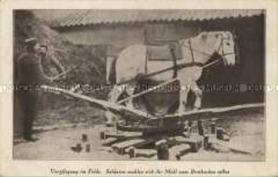 Soldat und Pferde beim mahlen
