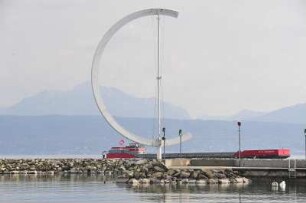 Lausanne - Hafen Ouchy : Hinter der Hafenmole fährt auf dem Genfer See ein Frachtschiff. Aufgenommen in Lausanne am 18. Mai 2010