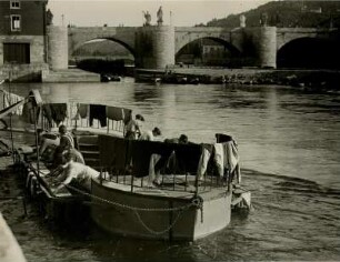 Würzburg. Waschtag am Main. Frauen waschen ihre Wäsche im Fluß. Im Hintergrund die Alte Mainbrücke, die die Altstadt mit der Festung Marienberg verbindet.