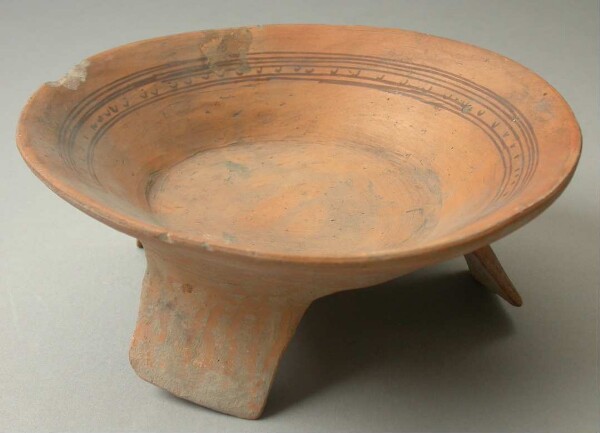 Three-footed clay bowl