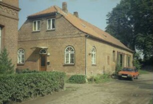 Altfresenburg 14: traufständiges Handwerkerhaus: Giebelseite Wohntrakt mit Eingangstür: Straßenfront, hinten Werkstatttrakt mit Rolltoren