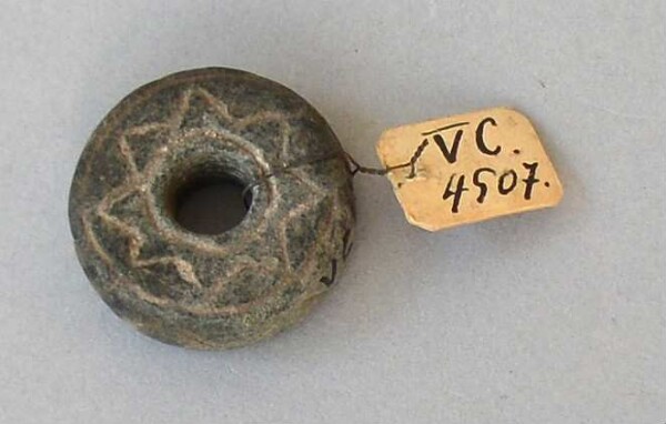 Stone decoration (spindle whorl)