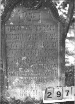 Grabstein 297 (Index: 99609934) Material: Sandstein Zustand: verwittert Maße HxBxT: 112x59x10 cm Beschreibung: Stele, Konvexbogenabschluß, Schriftfeld eingetieft, Kranz mit Rosette im Bogen, Levitenkanne Symbolik: Levitenkanne, Kranz, Rosette: Grabstein 297A