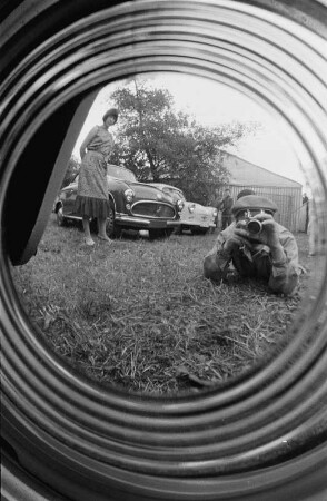 Spiegelungen. Der Fotograf, sich in der Radkappe eines PKWs spiegelnd