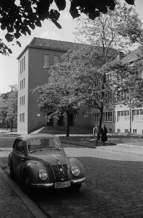 Straßenansicht mit einem Schulgebäude (?)