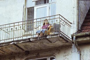 DDR. Junge Frau auf marodem Altbaubalkon (um 1910)