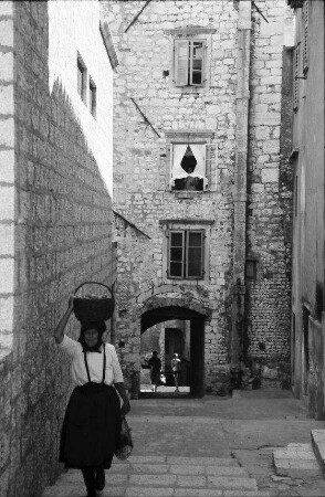 Sibenik: Gasse mit Frau, die Korb auf Kopf trägt