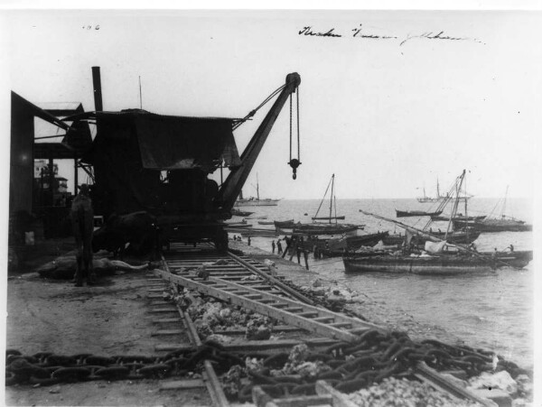 A crane in front of a customs house