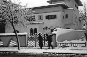 Bukarest: Verschneite Villa, Vordergrund laufen zwei Männer